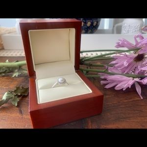 Pearl ring with diamond accents.